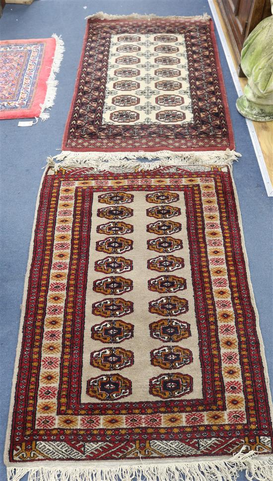 A red ground medallion rug and another 120 x 83cm, 120 x 79cm